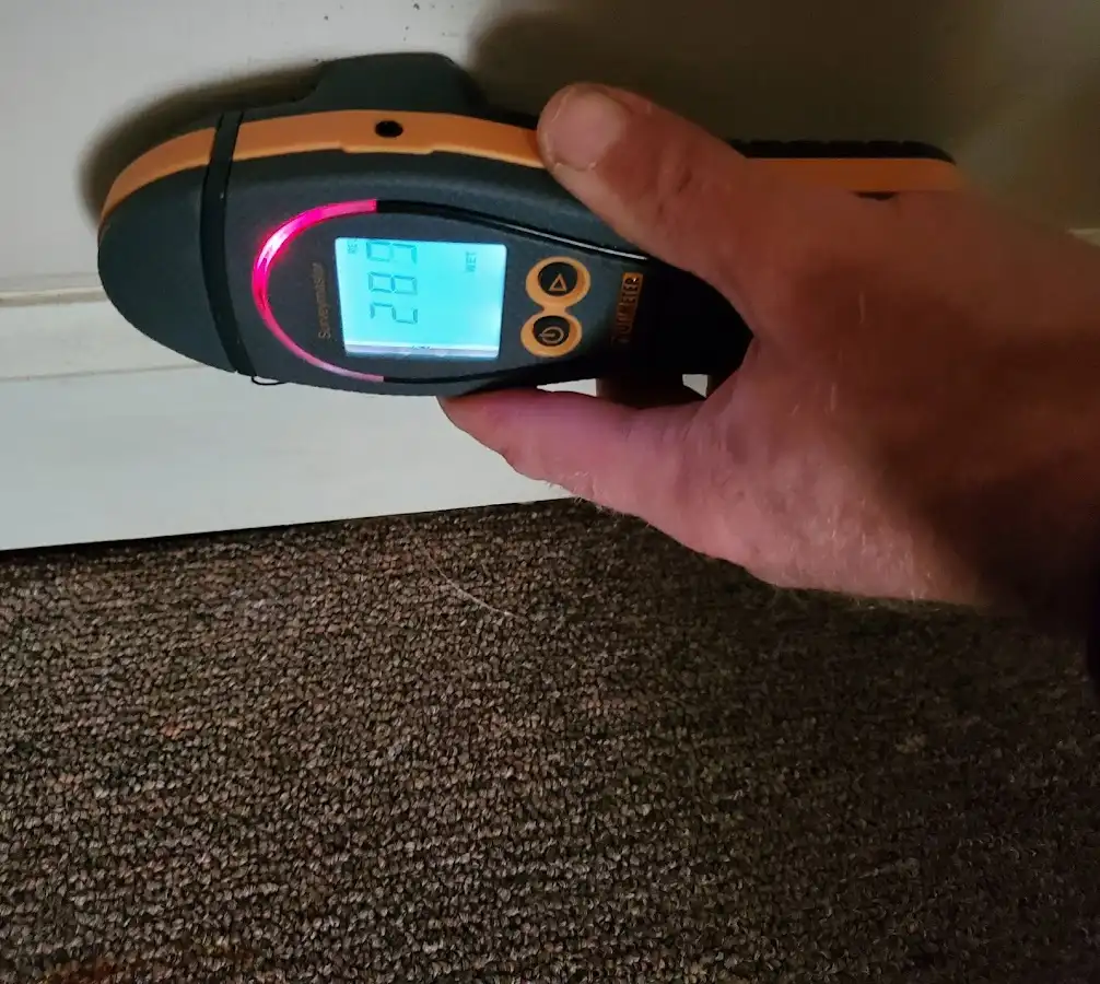 Moisture detection at baseboard during Storm Damage Restoration in Hutchison